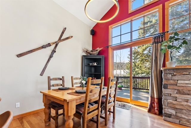 960 Whispering Pines Ln, Breckenridge, CO 80424 - dining area with high vaulted ceiling, baseboards, and wood finished floors