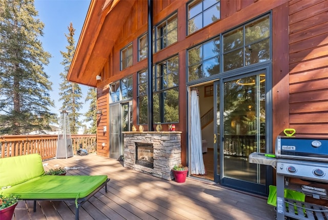 960 Whispering Pines Ln, Breckenridge, CO 80424 - wooden terrace with an outdoor stone fireplace and a grill
