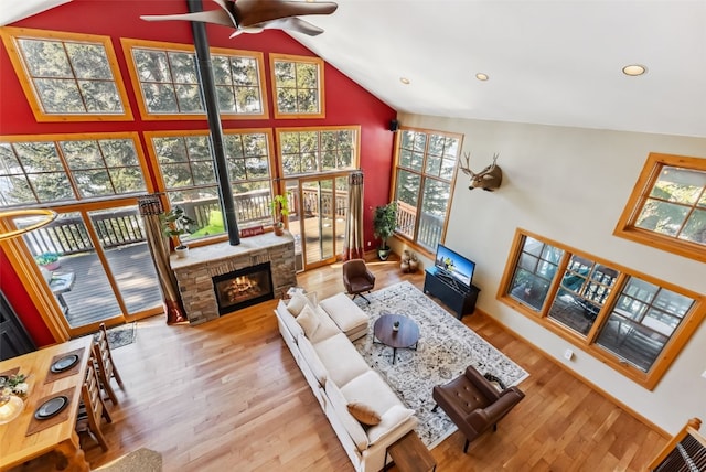 960 Whispering Pines Ln, Breckenridge, CO 80424 - living area featuring a fireplace, wood finished floors, a healthy amount of sunlight, and high vaulted ceiling