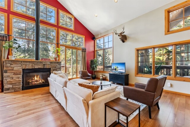 960 Whispering Pines Ln, Breckenridge, CO 80424 - living room with high vaulted ceiling, hardwood / wood-style flooring, and a fireplace