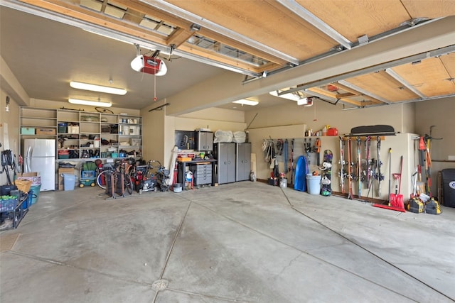 210 Game Trail Rd, Silverthorne, CO 80498 - garage featuring freestanding refrigerator and a garage door opener