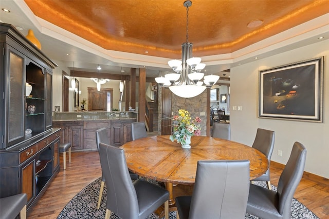 210 Game Trail Rd, Silverthorne, CO 80498 - dining room featuring wood finished floors, baseboards, recessed lighting, a raised ceiling, and a notable chandelier