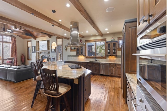 210 Game Trail Rd, Silverthorne, CO 80498 - kitchen with a sink, stainless steel appliances, beamed ceiling, a kitchen bar, and a center island