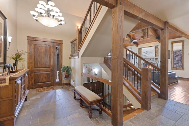210 Game Trail Rd, Silverthorne, CO 80498 - foyer with ceiling fan with notable chandelier, stairs, baseboards, and stone tile flooring