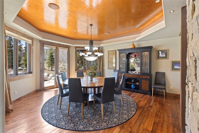 210 Game Trail Rd, Silverthorne, CO 80498 - dining room with a tray ceiling, an inviting chandelier, and baseboards
