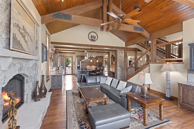 210 Game Trail Rd, Silverthorne, CO 80498 - living area featuring a ceiling fan, hardwood / wood-style floors, beamed ceiling, wooden ceiling, and stairs