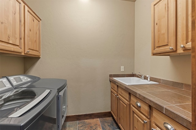 210 Game Trail Rd, Silverthorne, CO 80498 - laundry area featuring baseboards, washer and dryer, cabinet space, and a sink