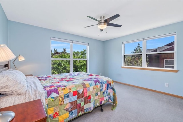2981 Abbey Rd, Steamboat Springs, CO 80487 - bedroom featuring multiple windows, carpet, and a ceiling fan