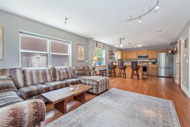 2981 Abbey Rd, Steamboat Springs, CO 80487 - living room with light wood finished floors, track lighting, and a chandelier