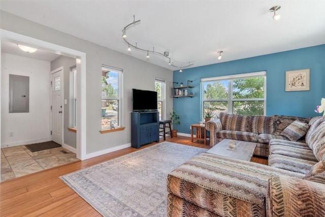 2981 Abbey Rd, Steamboat Springs, CO 80487 - living area with electric panel, plenty of natural light, and wood finished floors