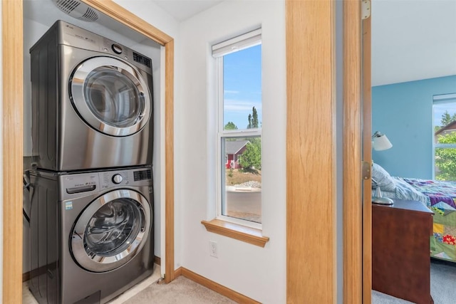 2981 Abbey Rd, Steamboat Springs, CO 80487 - laundry area featuring stacked washer / drying machine and carpet floors
