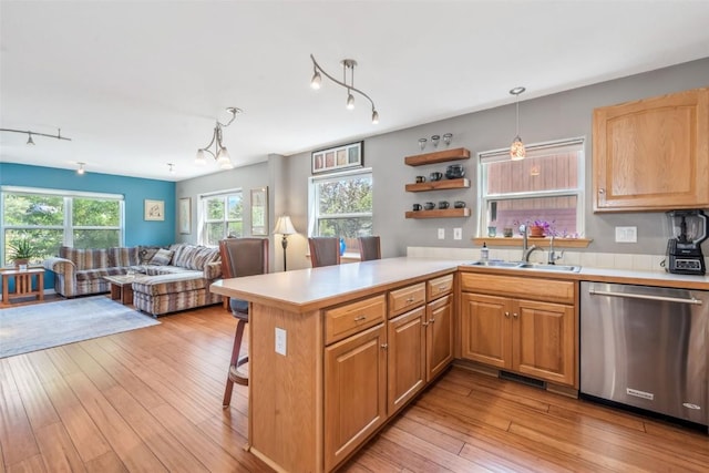 2981 Abbey Rd, Steamboat Springs, CO 80487 - kitchen with dishwasher, light countertops, rail lighting, and a kitchen bar