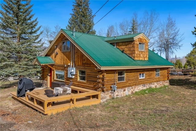 316 Hummingbird Cir, Silverthorne, CO 80498 - back of house featuring a deck, metal roof, log siding, and a lawn