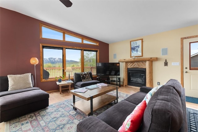 27426 Brandon Cir, Steamboat Springs, CO 80487 - living area featuring light wood finished floors, vaulted ceiling, a premium fireplace, and a ceiling fan
