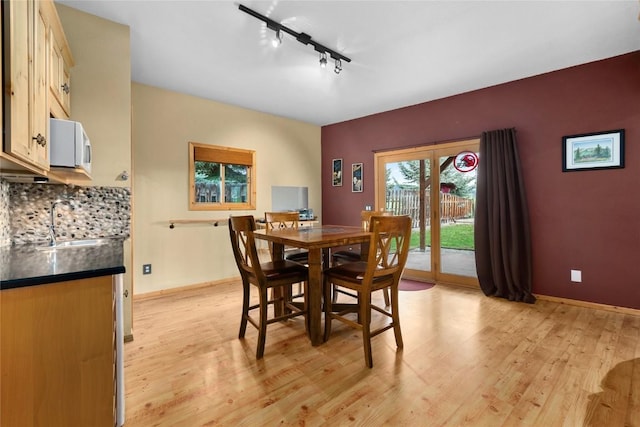 27426 Brandon Cir, Steamboat Springs, CO 80487 - dining space featuring light wood-style flooring, track lighting, and baseboards