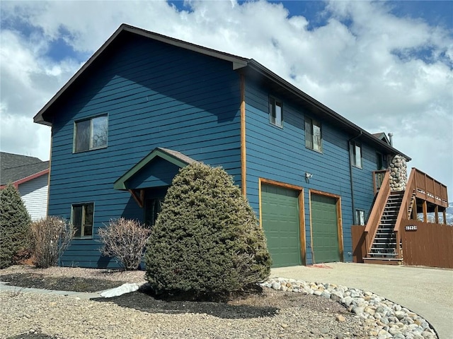 27426 Brandon Cir, Steamboat Springs, CO 80487 - view of front of home featuring stairs, an attached garage, driveway, and a deck