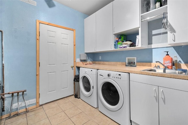 27426 Brandon Cir, Steamboat Springs, CO 80487 - laundry area with washing machine and clothes dryer, cabinet space, and light tile patterned flooring