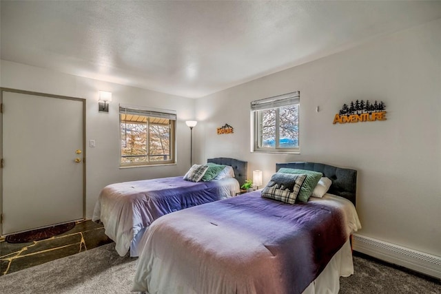 370 E Ln Bonte St Unit A, Dillon, CO 80435 - bedroom featuring a baseboard heating unit, baseboards, and carpet flooring