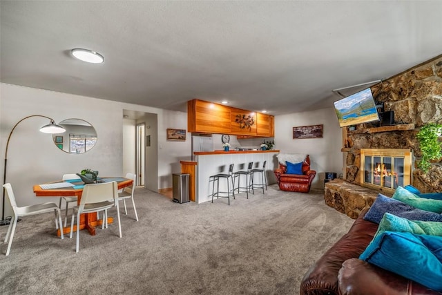 370 E Ln Bonte St Unit A, Dillon, CO 80435 - living area featuring a fireplace, baseboards, and light carpet