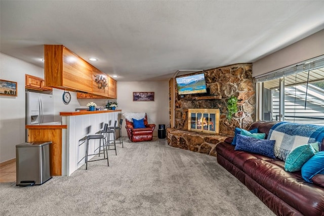 370 E Ln Bonte St Unit A, Dillon, CO 80435 - living room featuring recessed lighting, a stone fireplace, a bar, and light carpet