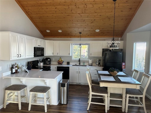 kitchen with a sink, dark wood finished floors, vaulted ceiling, wood ceiling, and black appliances