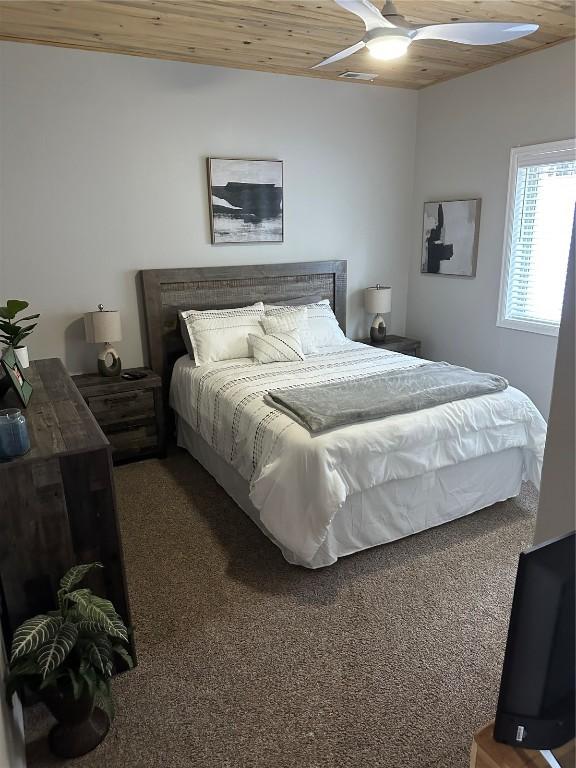 bedroom with wooden ceiling and carpet