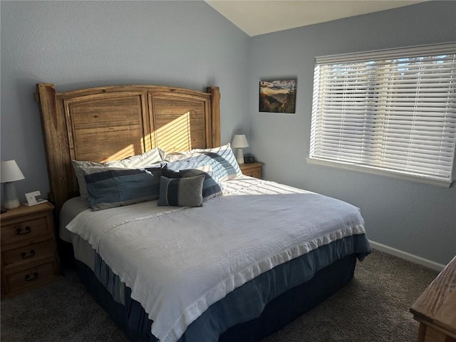 carpeted bedroom with lofted ceiling and baseboards