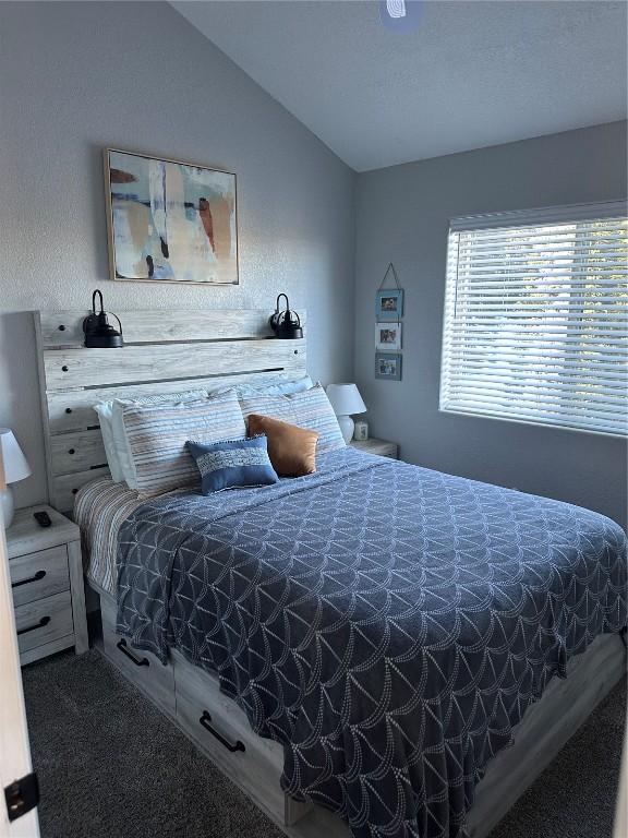 carpeted bedroom featuring vaulted ceiling