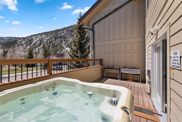 101 E Main St Unit 301, Frisco, CO 80443 - wooden deck with a mountain view and an outdoor hot tub