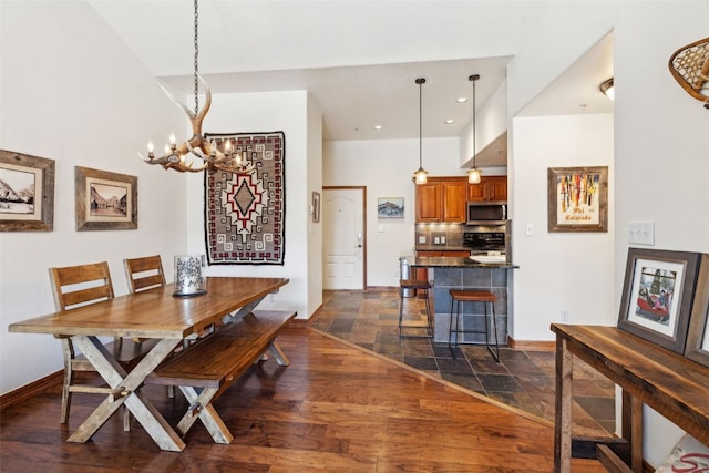 101 E Main St Unit 301, Frisco, CO 80443 - dining area featuring a chandelier, baseboards, dark stone finish floors, and recessed lighting