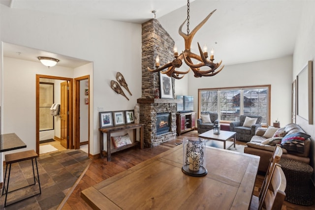 101 E Main St Unit 301, Frisco, CO 80443 - living room with a chandelier, a stone fireplace, wood finished floors, and baseboards