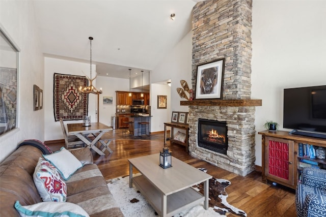 101 E Main St Unit 301, Frisco, CO 80443 - living area with wood finished floors, high vaulted ceiling, a chandelier, and a stone fireplace