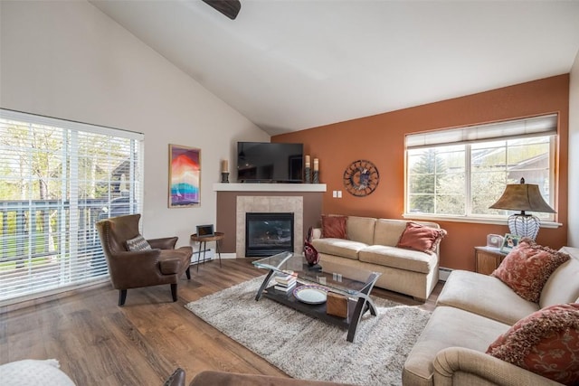 1399 Morgan Ct Unit 704, Steamboat Springs, CO 80487 - living room with wood finished floors, a tiled fireplace, and high vaulted ceiling