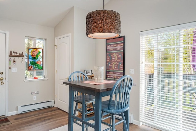 1399 Morgan Ct Unit 704, Steamboat Springs, CO 80487 - dining space with a baseboard heating unit, wood finished floors, and baseboards