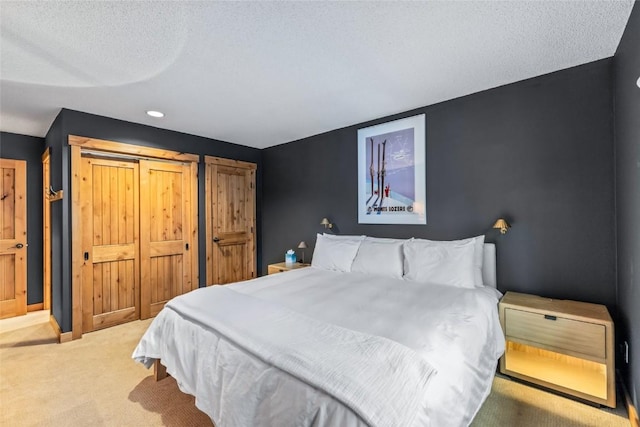 1655 Ranch Rd Unit 403, Steamboat Springs, CO 80487 - bedroom with carpet floors, a textured ceiling, baseboards, and recessed lighting