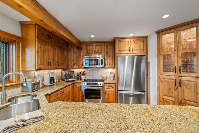 1655 Ranch Rd Unit 403, Steamboat Springs, CO 80487 - kitchen featuring stainless steel appliances, a sink, light stone counters, tasteful backsplash, and recessed lighting