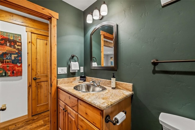 1655 Ranch Rd Unit 403, Steamboat Springs, CO 80487 - bathroom with toilet, vanity, and wood finished floors