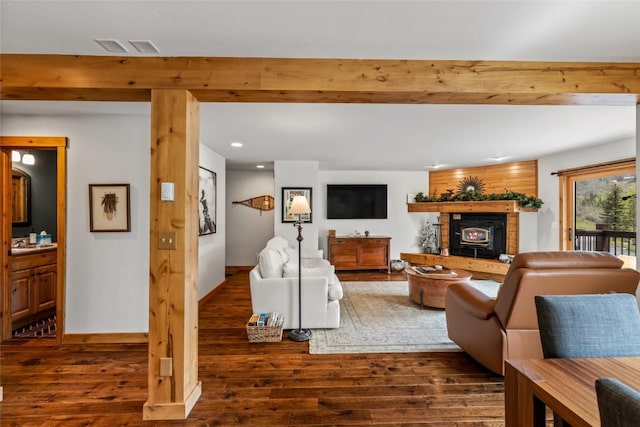 1655 Ranch Rd Unit 403, Steamboat Springs, CO 80487 - living area with wood finished floors, a fireplace with raised hearth, recessed lighting, beam ceiling, and baseboards