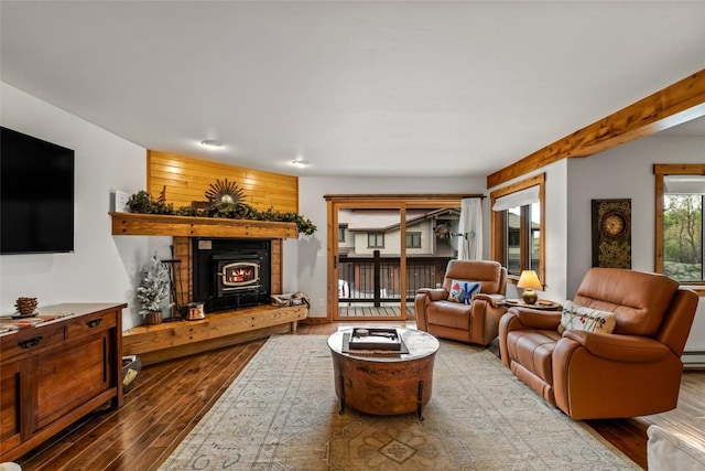 1655 Ranch Rd Unit 403, Steamboat Springs, CO 80487 - living room with wood finished floors, a lit fireplace, and a baseboard radiator