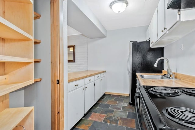 6 Sequoia Ct Unit 6, Steamboat Springs, CO 80487 - kitchen featuring stone finish flooring, a sink, white cabinetry, black range with electric stovetop, and light countertops