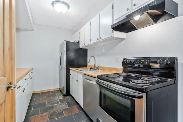 6 Sequoia Ct Unit 6, Steamboat Springs, CO 80487 - kitchen featuring stainless steel appliances, under cabinet range hood, a sink, stone finish floors, and white cabinets