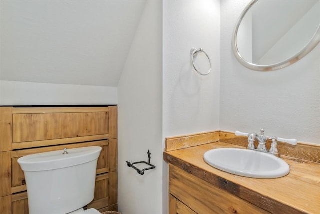 6 Sequoia Ct Unit 6, Steamboat Springs, CO 80487 - half bathroom with lofted ceiling, vanity, and toilet