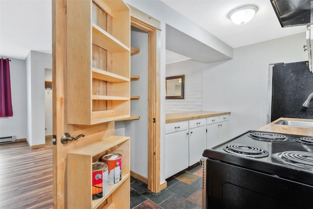 6 Sequoia Ct Unit 6, Steamboat Springs, CO 80487 - kitchen featuring black range with electric cooktop, white cabinetry, a sink, open shelves, and freestanding refrigerator