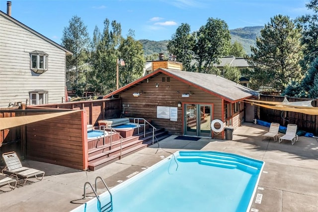 6 Sequoia Ct Unit 6, Steamboat Springs, CO 80487 - rear view of property with a jacuzzi, a mountain view, a patio, and french doors