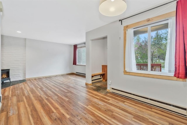 6 Sequoia Ct Unit 6, Steamboat Springs, CO 80487 - unfurnished living room with a baseboard heating unit, wood finished floors, a baseboard radiator, and baseboards