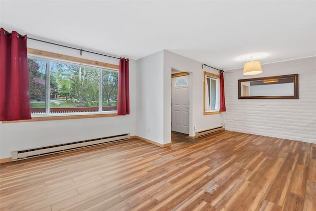6 Sequoia Ct Unit 6, Steamboat Springs, CO 80487 - empty room with a baseboard heating unit, wood finished floors, baseboards, and brick wall