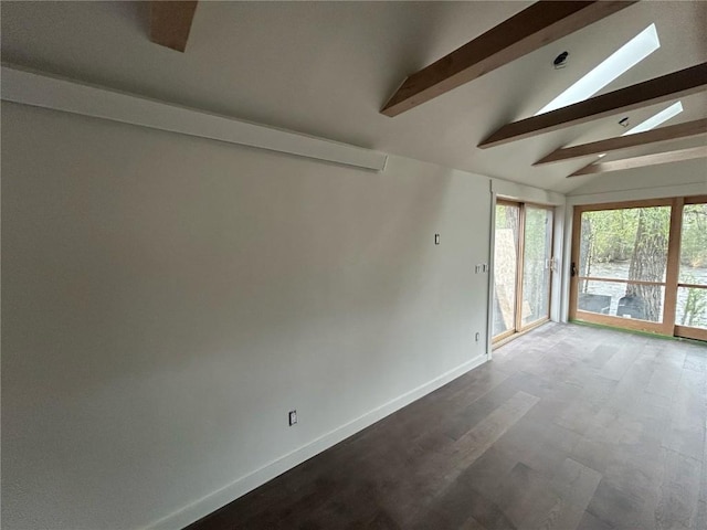 1325 Dream Island Plz Unit 18, Steamboat Springs, CO 80487 - empty room featuring a skylight, dark wood-style floors, and baseboards