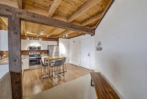 8500 Ryan Gulch Rd Unit 101, Silverthorne, CO 80498 - dining area with wood ceiling, beam ceiling, and light wood finished floors