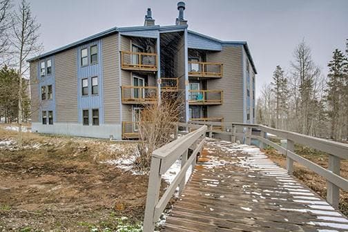 8500 Ryan Gulch Rd Unit 101, Silverthorne, CO 80498 - rear view of property featuring a chimney