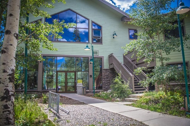 8500 Ryan Gulch Rd Unit 101, Silverthorne, CO 80498 - rear view of house featuring french doors, stairs, and stone siding